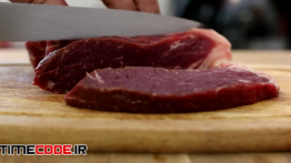 دانلود استوک فوتیج : برش زدن گوشت در آشپزخانه Cutting Beef With A Knife
