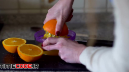 دانلود استوک فوتیج : زن در حال گرفتن آب پرتغال Woman Makes Orange Juice