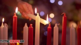 دانلود استوک فوتیج : نما آهسته از روشن کردن شمع Red And White Candles Being Lit