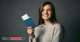 دانلود استوک فوتیج مفهومی : دختر خوشحال همراه با بلیط هواپیما Girl Happy With Airplane Ticket