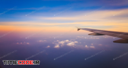 دانلود عکس استوک : بال هواپیما در طلوع خورشید Airplane In The Sky At Sunrise