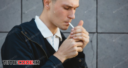 دانلود عکس استوک : مرد جوان در حال سیگار کشیدن Fashion Hipster Male Model Smoking