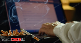 دانلود عکس استوک : سیگار کشیدن در هنگام کار با کامپیوتر Man Working On Laptop With Smoking Cigarette