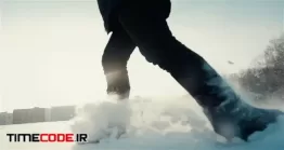 دانلود فوتیج راه رفتن در برف Athlete Woman Is Running During Winter