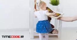 دانلود نوزاد دختر در حال بازی با کتاب Cute Baby Girl Playing Indoors
