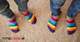 دانلود عکس پسران با جوراب رنگی Gay Couple With Colorful Socks Standing On Carpet