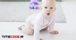 دانلود نوزاد در حال چهار دست و پا راه رفتن Portrait Of A Cute Baby Crawling And Laughing On The Floor