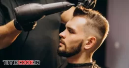 دانلود عکس مرد در آرایشگاه مردانه در حال سشوار Handsome Man At A Barber Shop Styling Hair