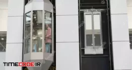 دانلود عکس آسانسور شیشه ای A Person Standing In Moving Elevator Inside Large Contemporary Mall