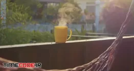 دانلود فوتیج لیوان چای داغ در تراس Steaming Hot Cup Of Tea On The Terrace