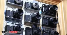 دانلود فوتیج دوربین عکاسی آنالوگ Old Film Photo Cameras On The Wall In Photographic Studio