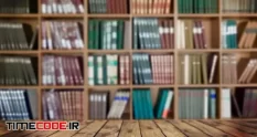 wooden tabletop blurred book shelf background 23798783 27 49 966