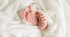 close up baby feet bed 110980795 cover 1